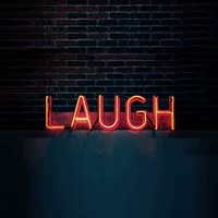 Comedy sign displaying laugh in neon