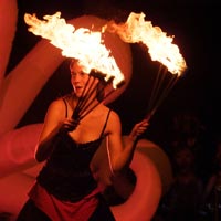 Roving performer twirling fire