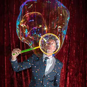Roving performer giant bubble blower